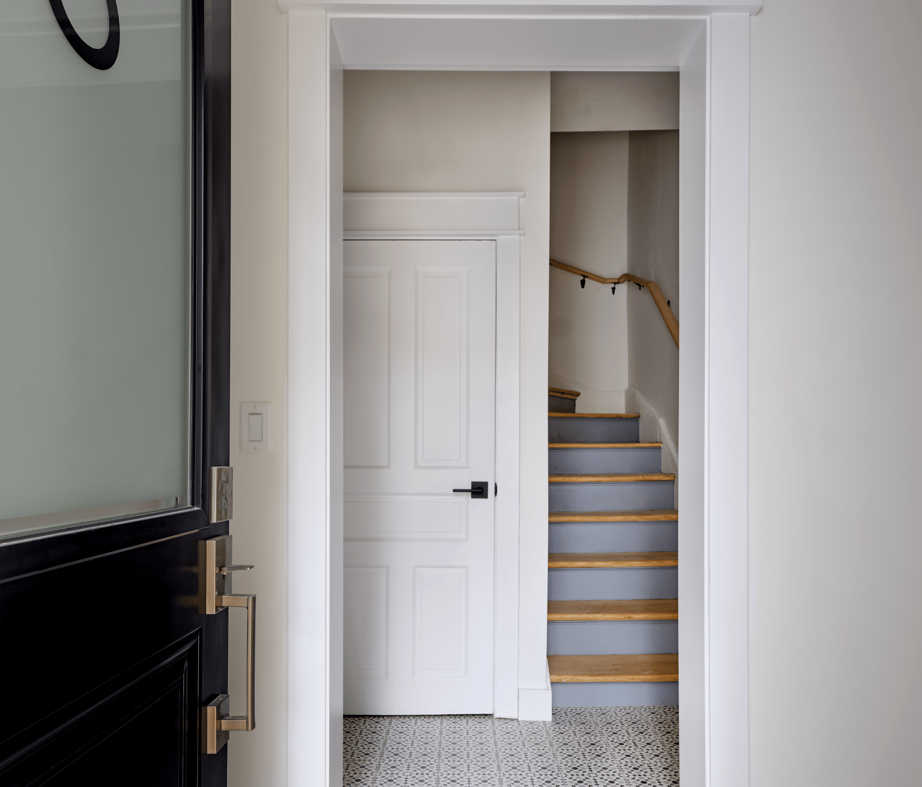 A white door is open to a staircase.